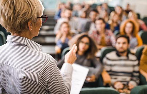 A professor lectures in front of a class